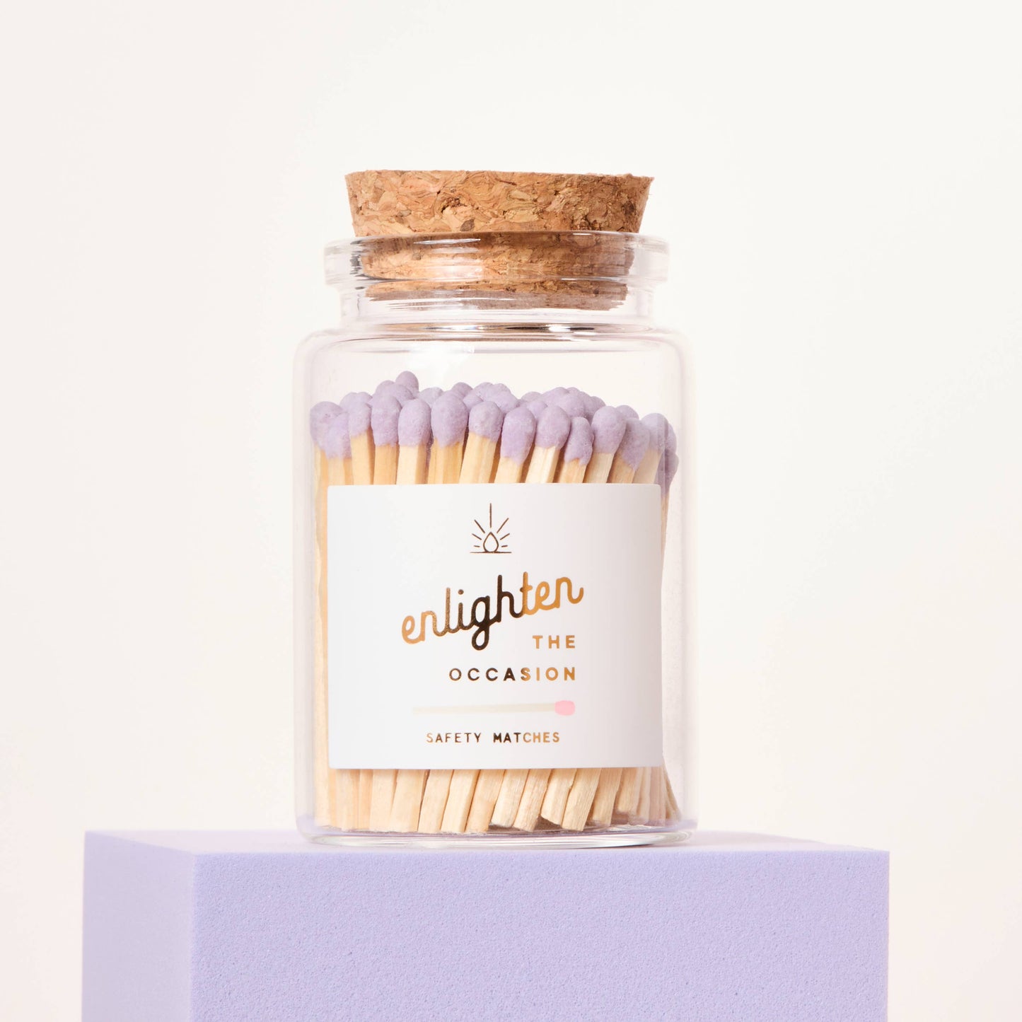 Jar of matches with cork lid on a white background