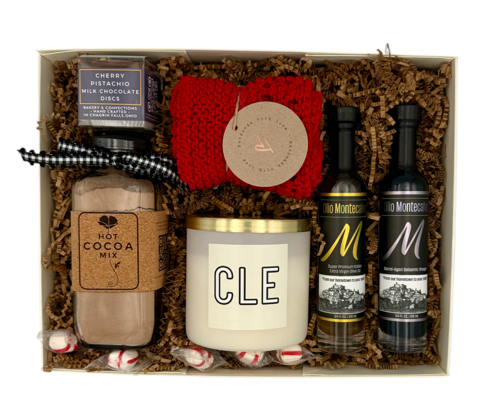 Gift set with a candle, hot cocoa mix, and other items in a box.