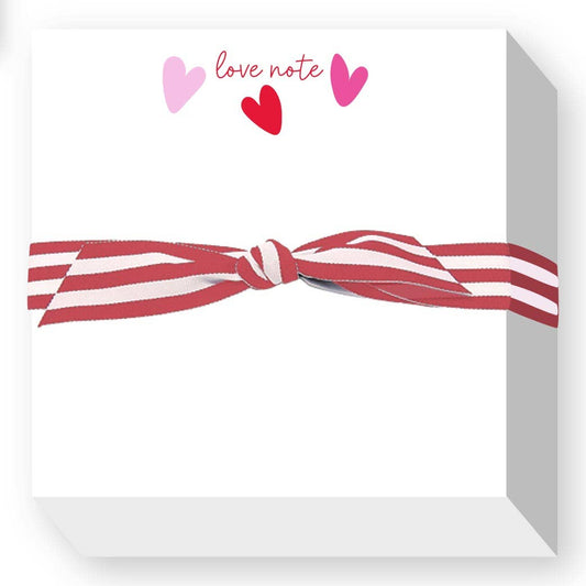Note card with red and white striped bow and hearts on a white background