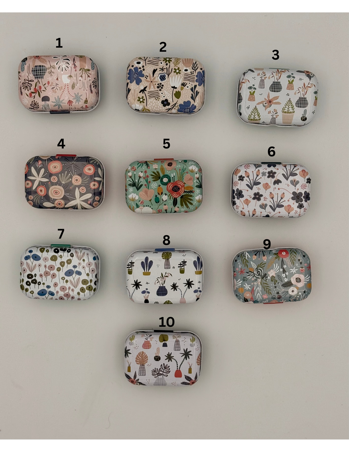 Ten small fabric pouches with various patterns arranged in a 3x3 grid on a white background.