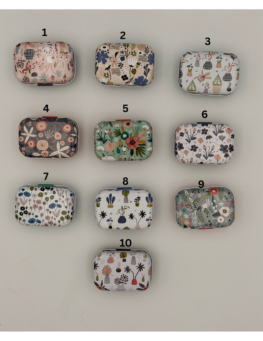 Ten small fabric pouches with various patterns arranged in a 3x3 grid on a white background.