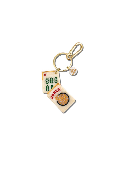 Keychain with mahjong card design on a white background