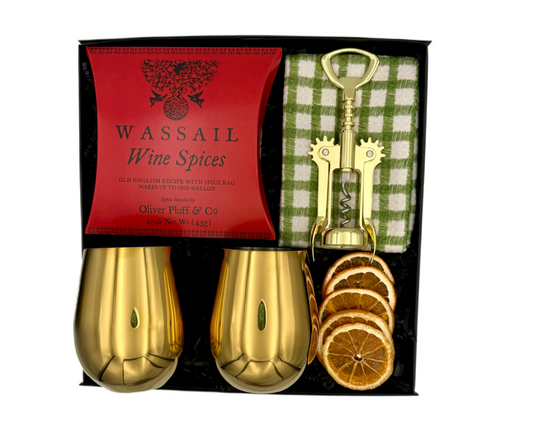 Wassail wine spices set with gold shakers, bottle opener, and dried oranges in a black box.