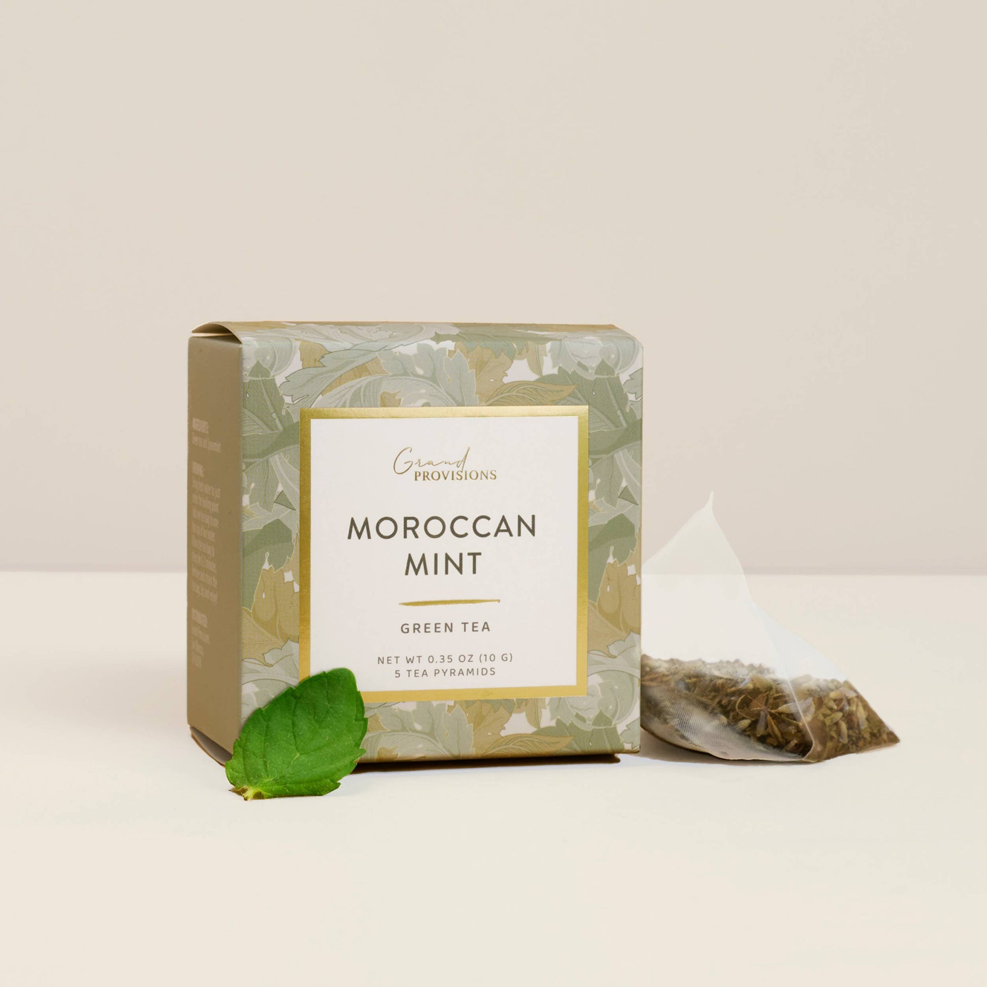 Moroccan Mint green tea packaging with a tea leaf on a light background