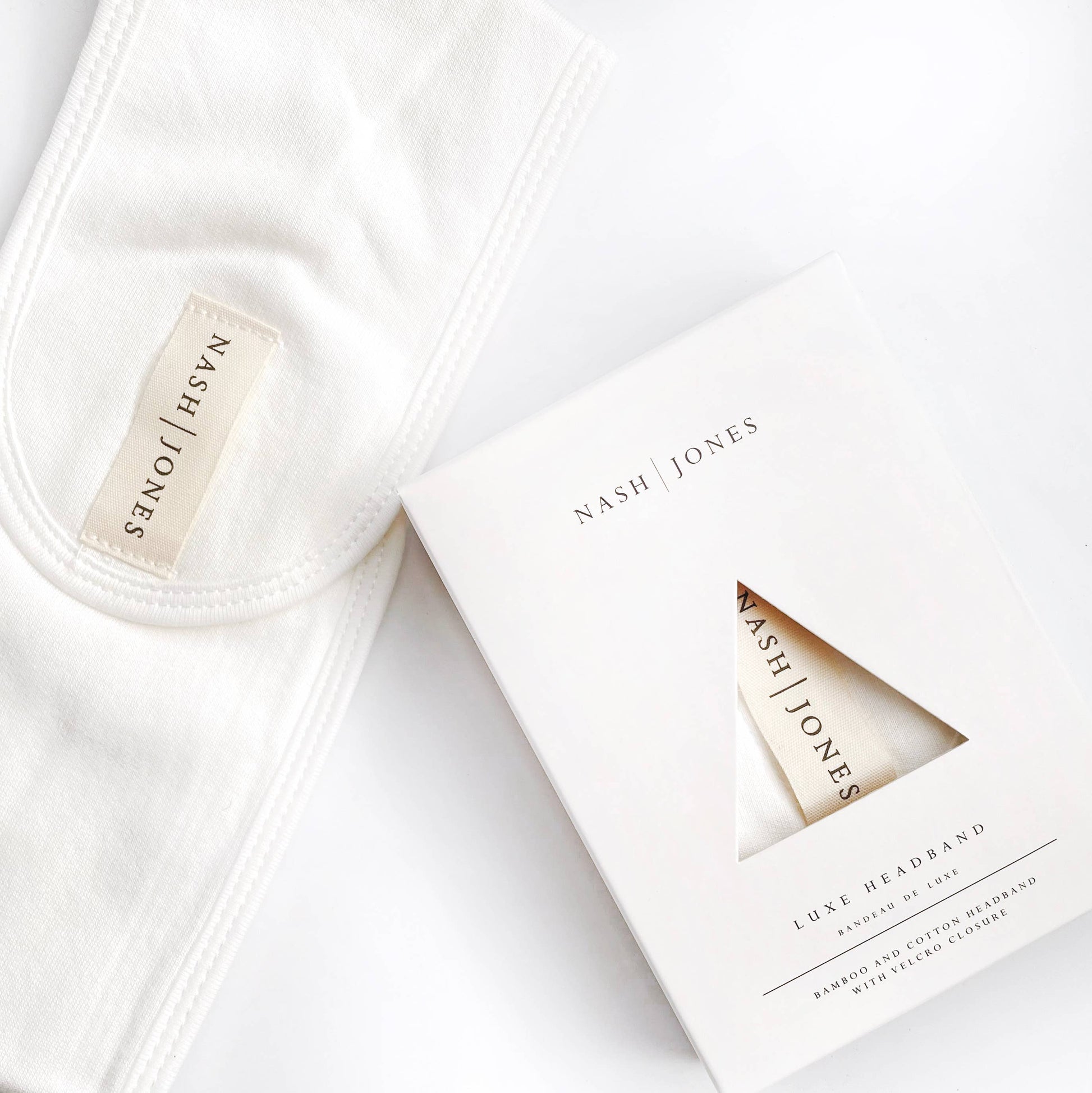 White headbands with 'Nash Jones' branding on packaging and labels.