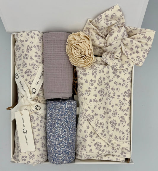 Set of baby blankets and headbands in a box with floral patterns.