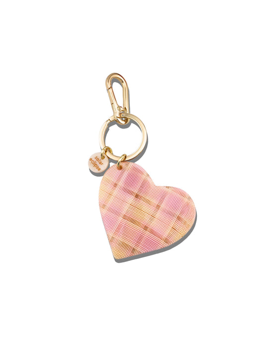 Heart-shaped keychain with pink plaid pattern on a white background