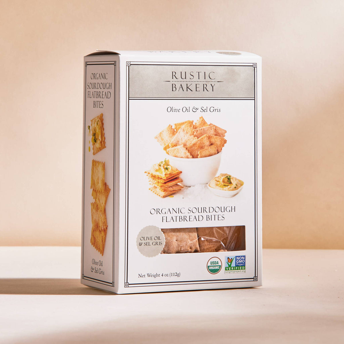 Box of Rustic Bakery organic sourdough flatbread bites on a beige background