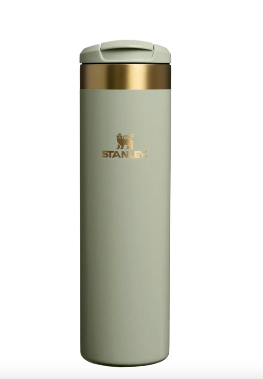 Light gray Stanley insulated mug with gold lid on a white background