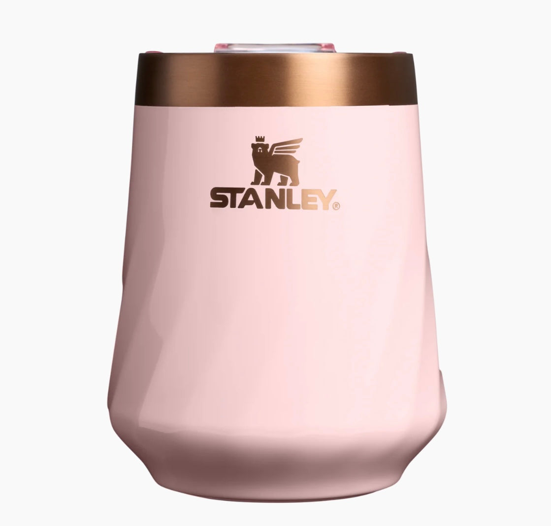 Pink insulated cup with bronze rim and Stanley logo on a white background