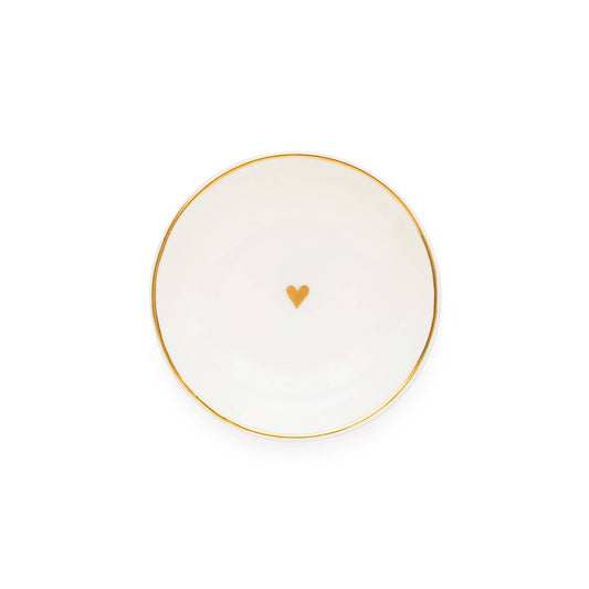 White plate with a gold rim and heart design on a white background