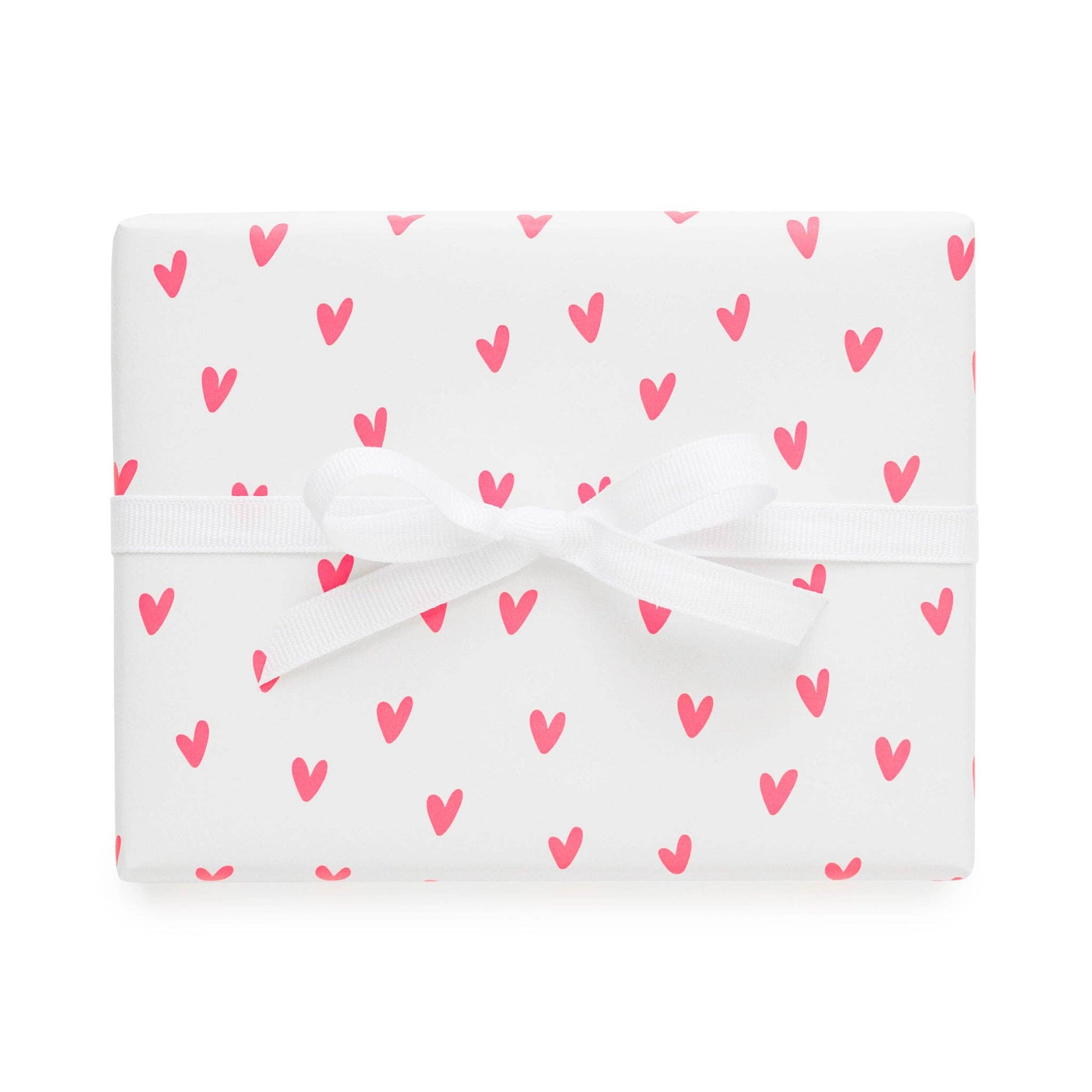 White fabric with pink heart pattern on a white background