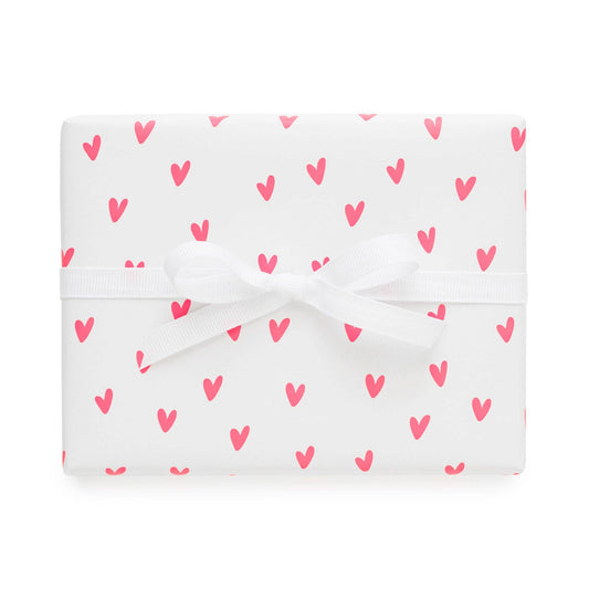White fabric with pink heart pattern on a white background