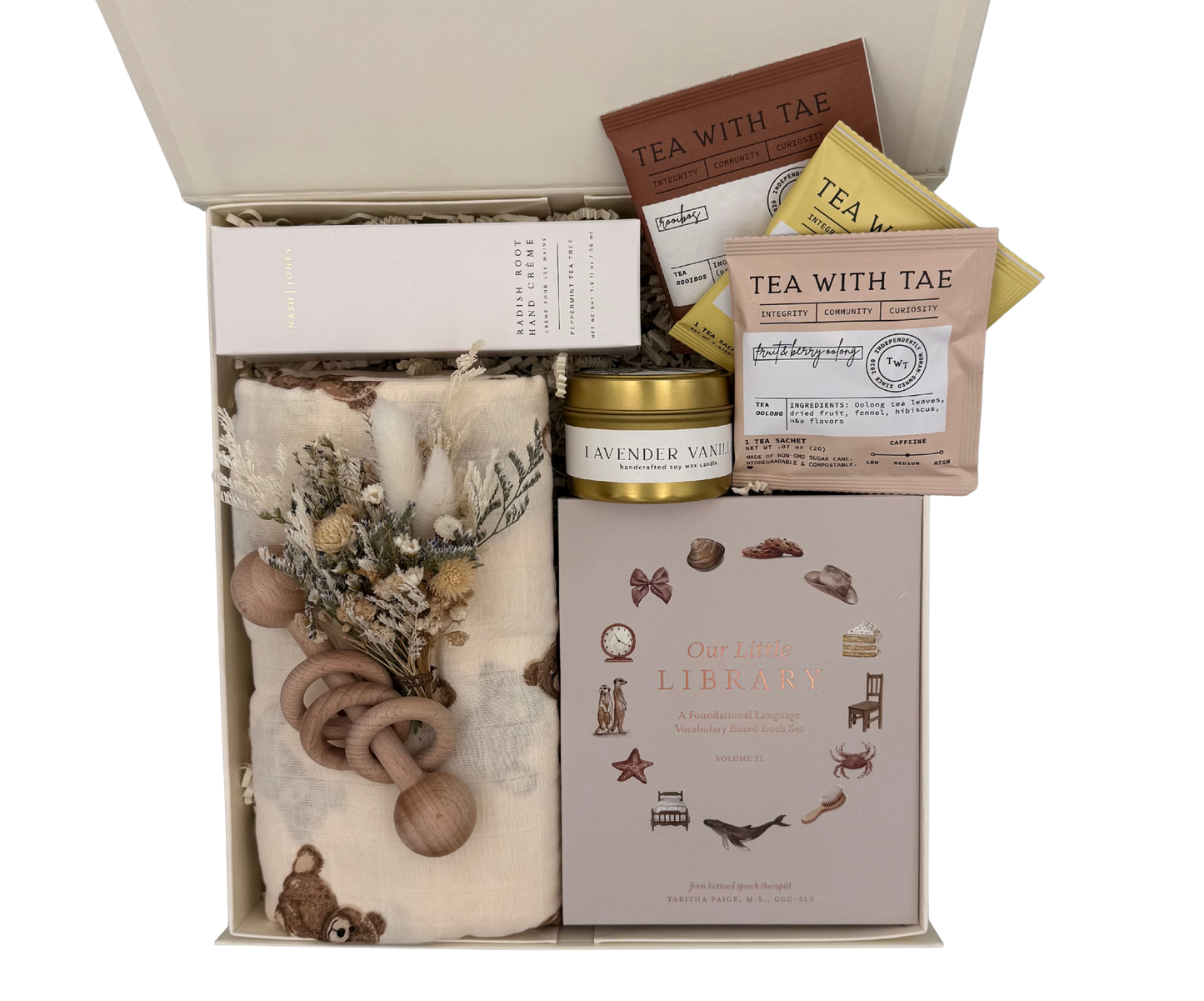 Gift set with tea, candle, and baby items in a box