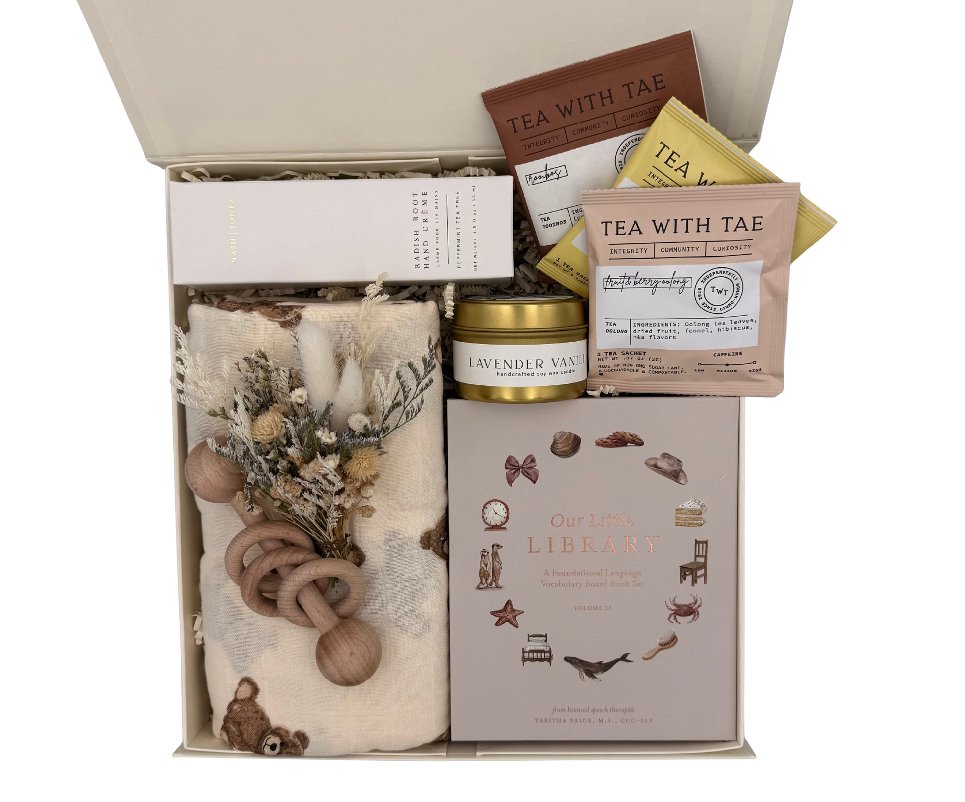 Gift set with tea, candle, and baby items in a box
