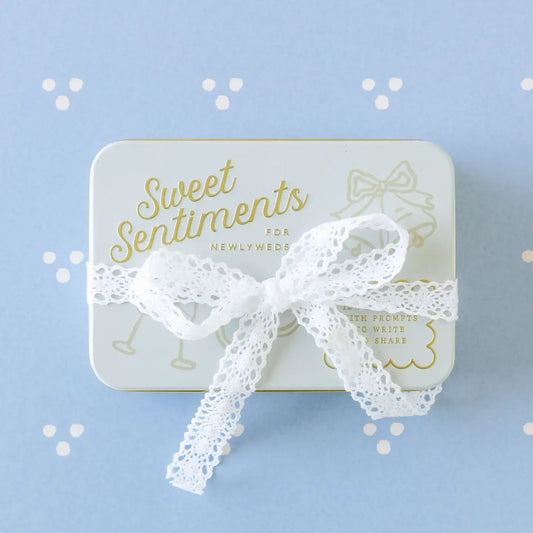 Gift box with lace bow on a light blue background