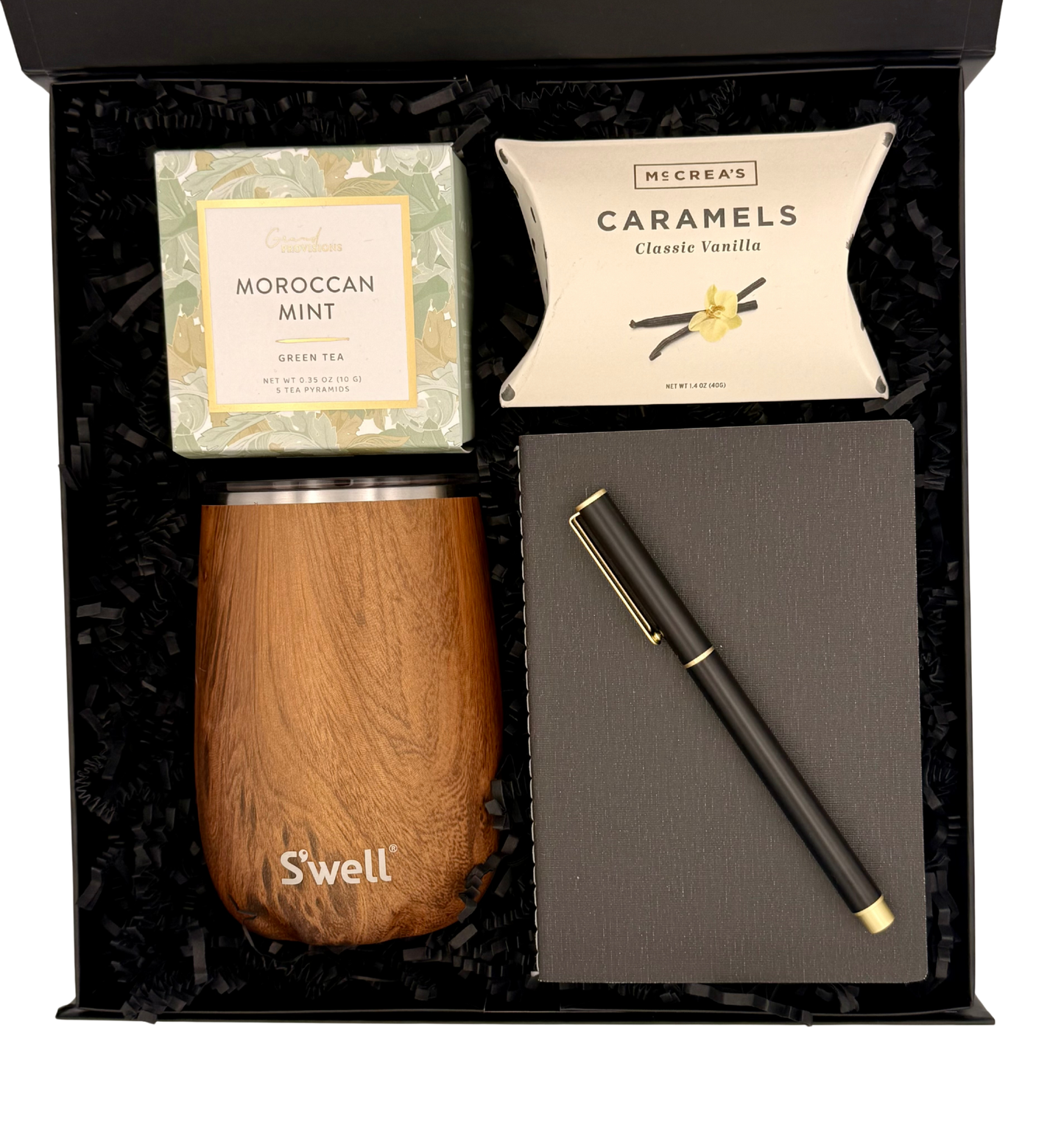 Gift set with wooden cup, notebook, pen, and tea包 in a black box