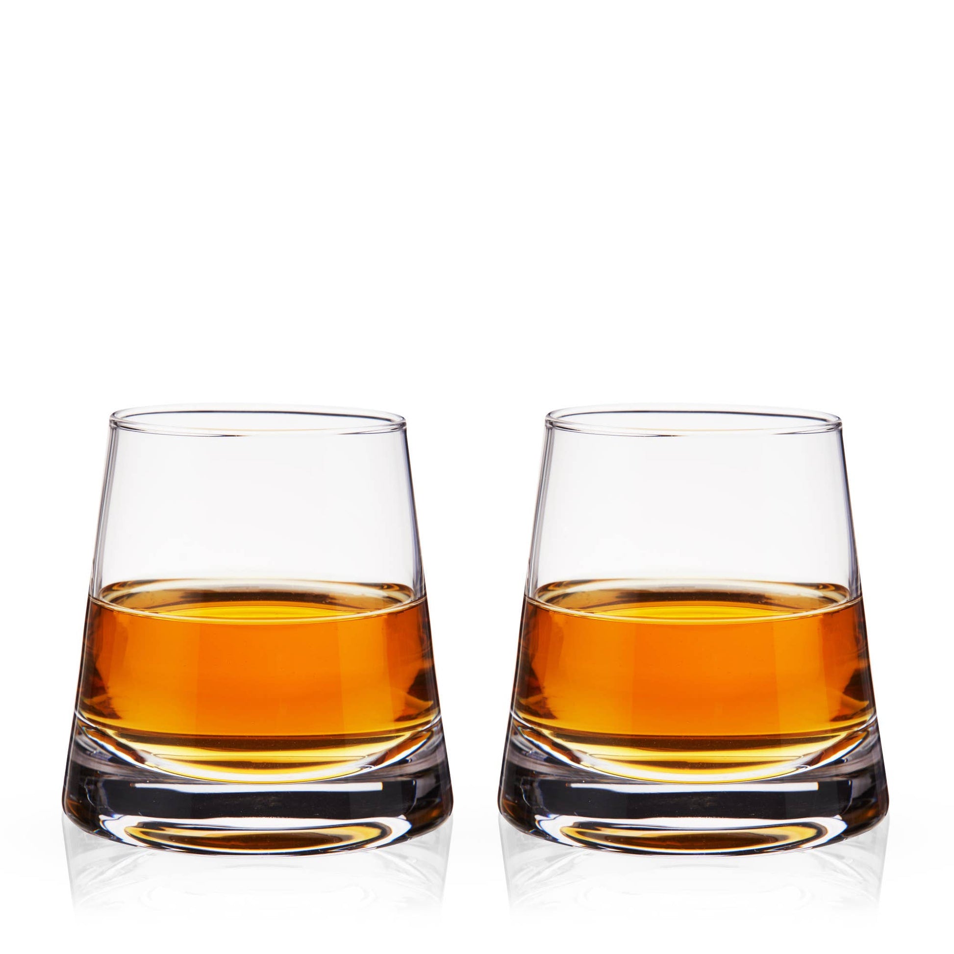 Two glasses of amber liquid on a white background