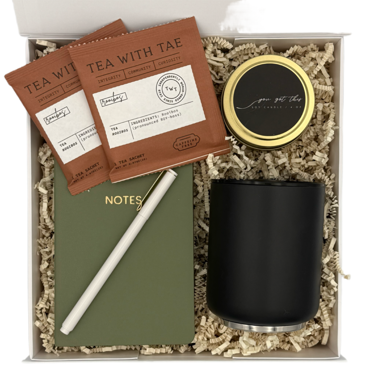 Gift set with tea, notebook, pen, and candle in a box